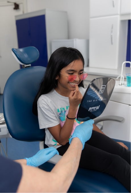 Young girl looking at results in mirror