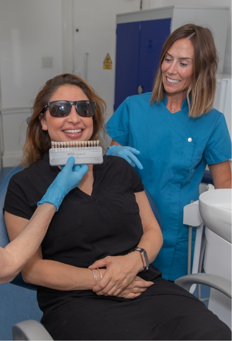 Patient comparing teeth shades