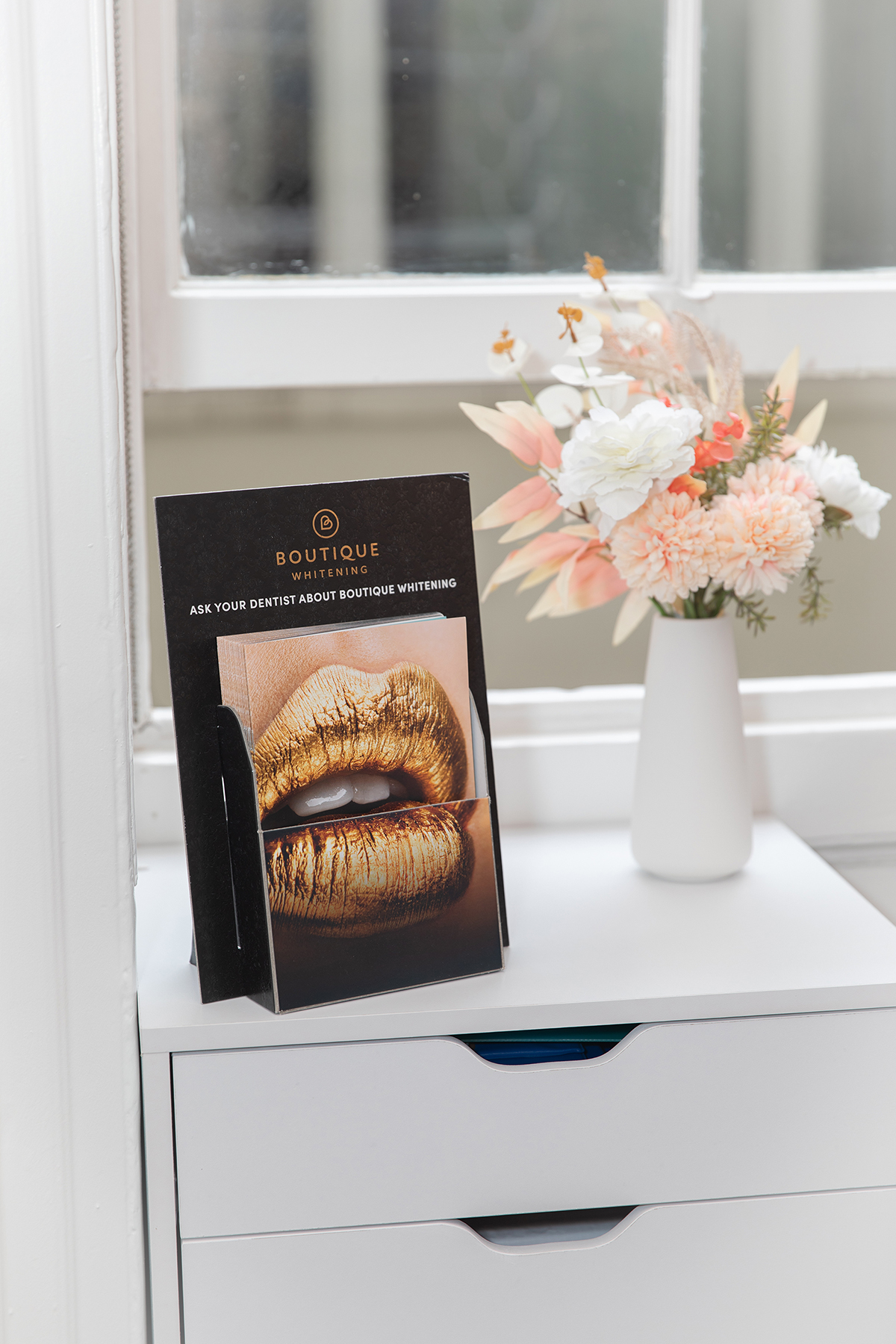 Brochures on stand with flowers